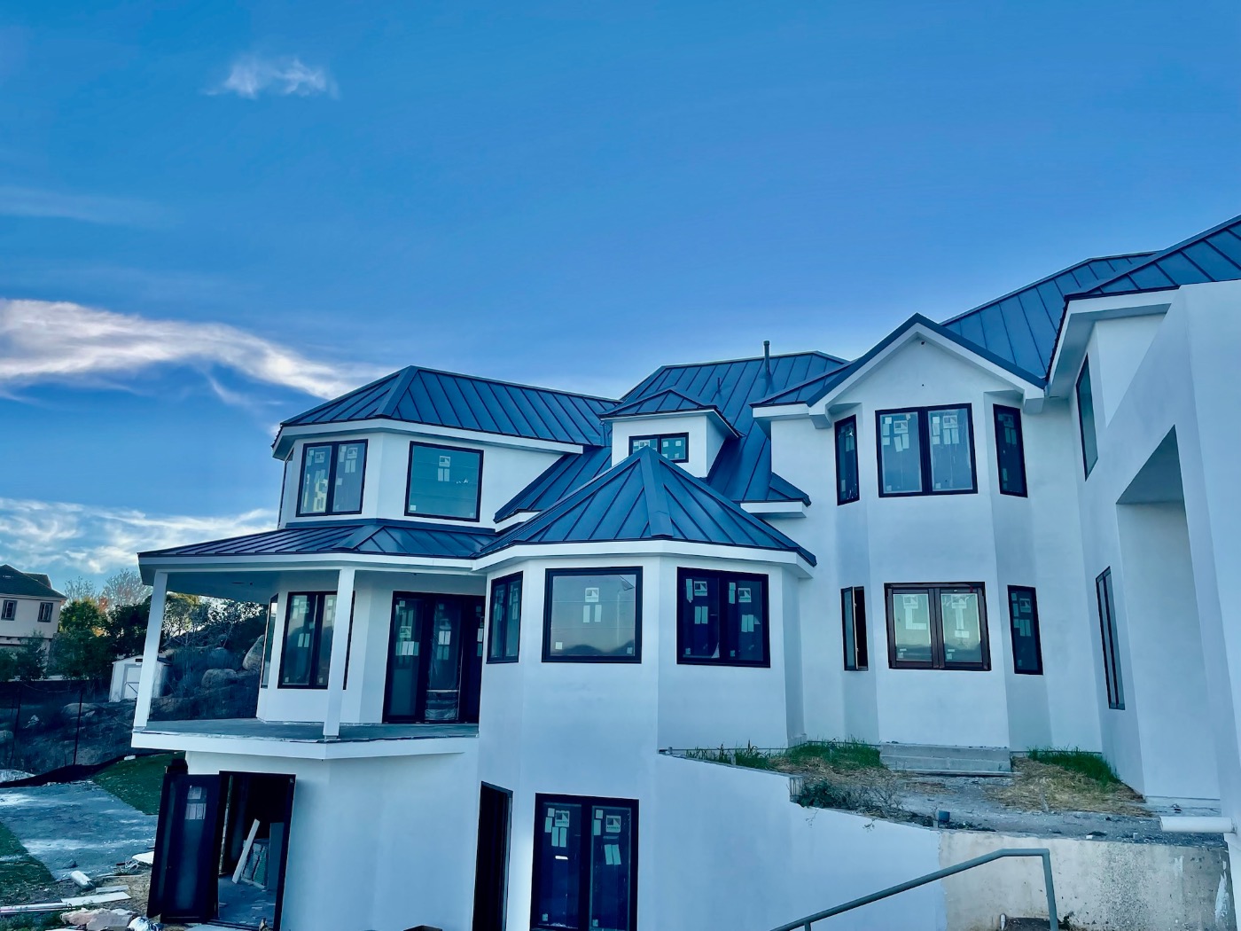 Standing seam metal roof on white modern home